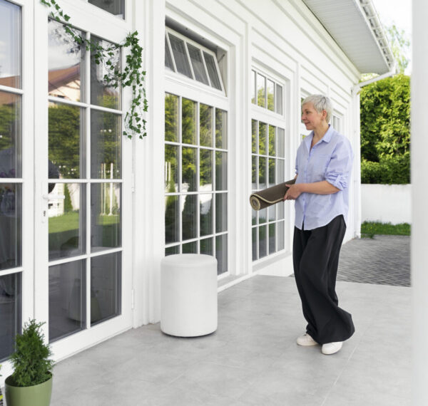 full-shot-woman-decorating-front-door-outside
